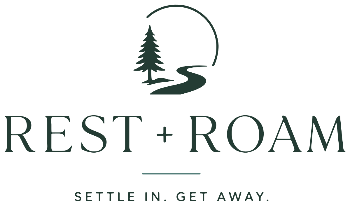 Rest + Roam RV Resort logo, a pine tree and winding road with the words Settle in. Get away.